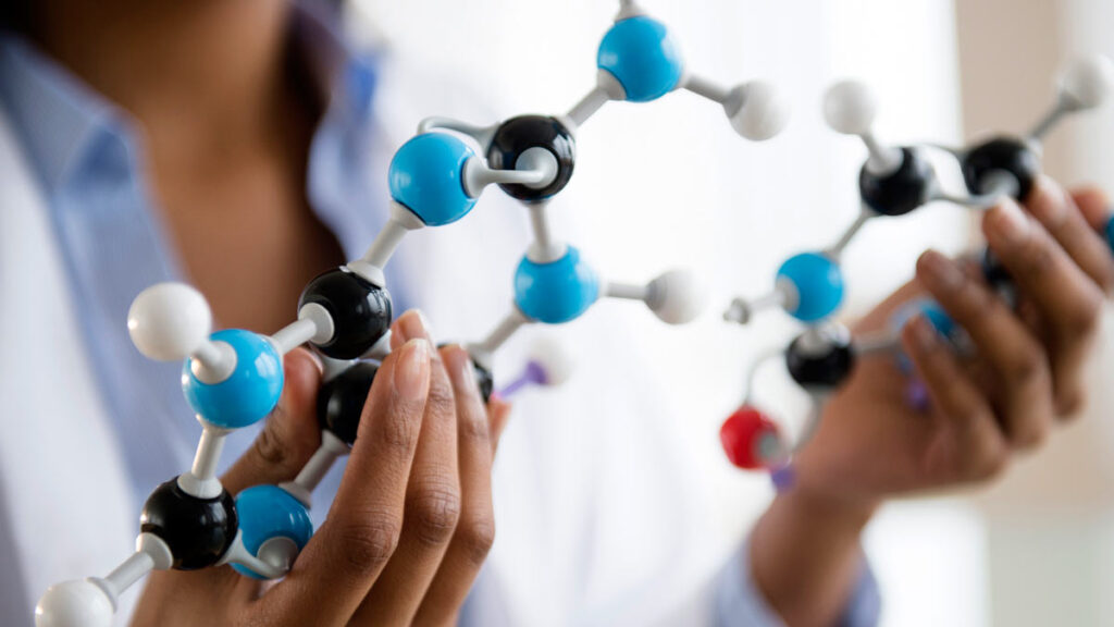 scientist examining molecular model